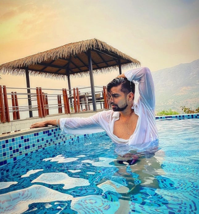 Young handsome man posing near a pool - a Royalty Free Stock Photo from  Photocase